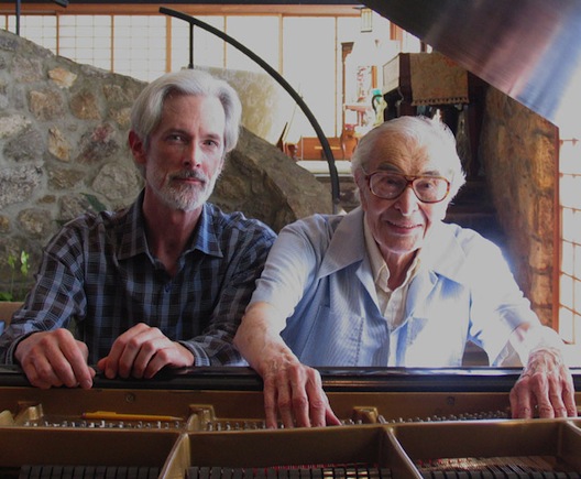 Photo of Dave Brubeck and Terry Flynn behind David Brueck's piano.