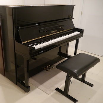 Upright piano sales represented with photo of high gloss black Yamaha Upright